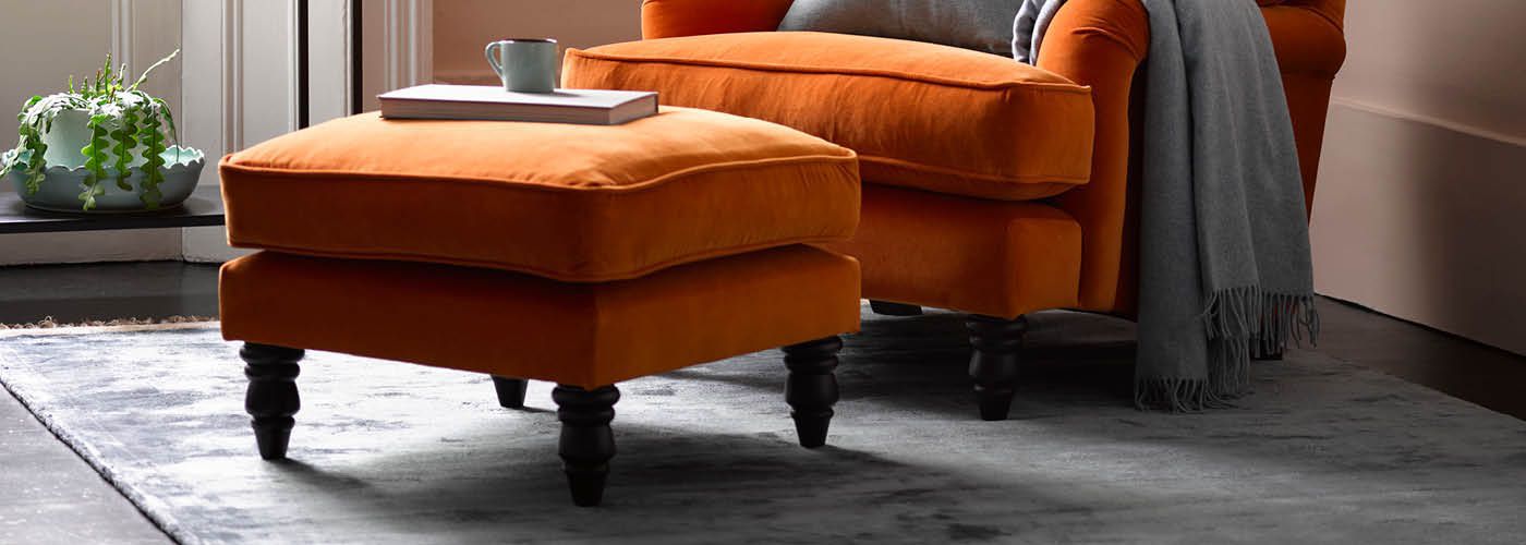 Orange fabric footstool with Bluebell Armchair