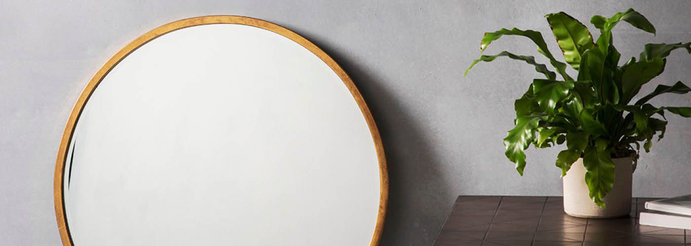 Round wooden frame mirror in contemporary living space