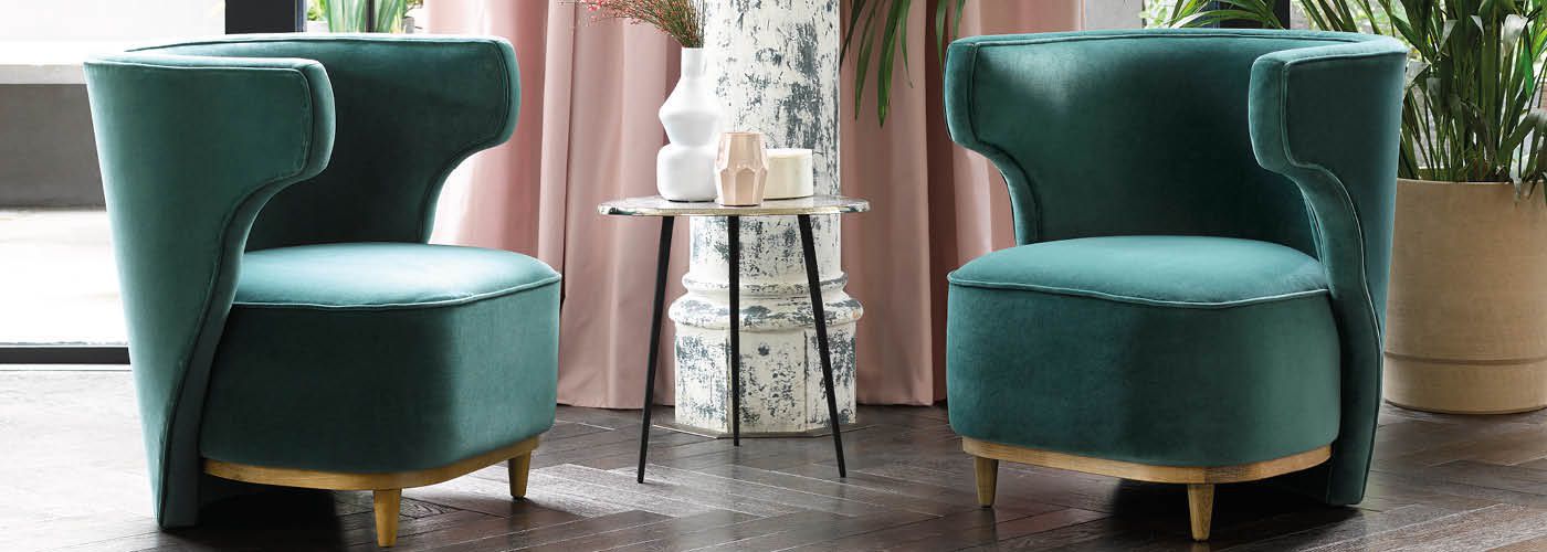 Green velvet edie armchair in furnished room